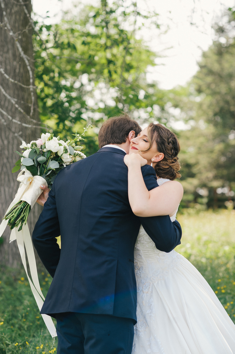 bride and groom hugging after first look