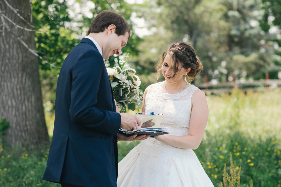 bride giving groom a handmade scrapbook gift