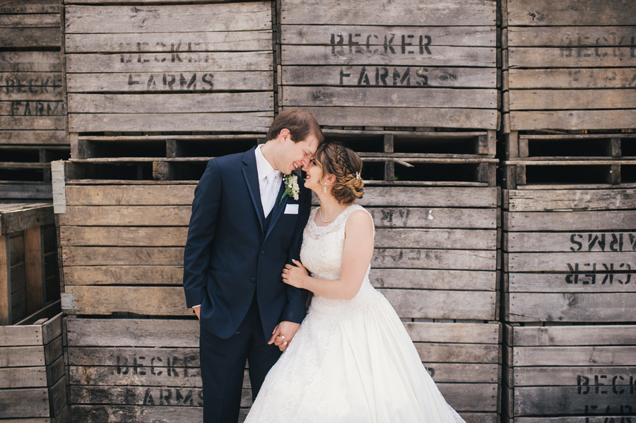 bride and groom touching foreheads and smiling