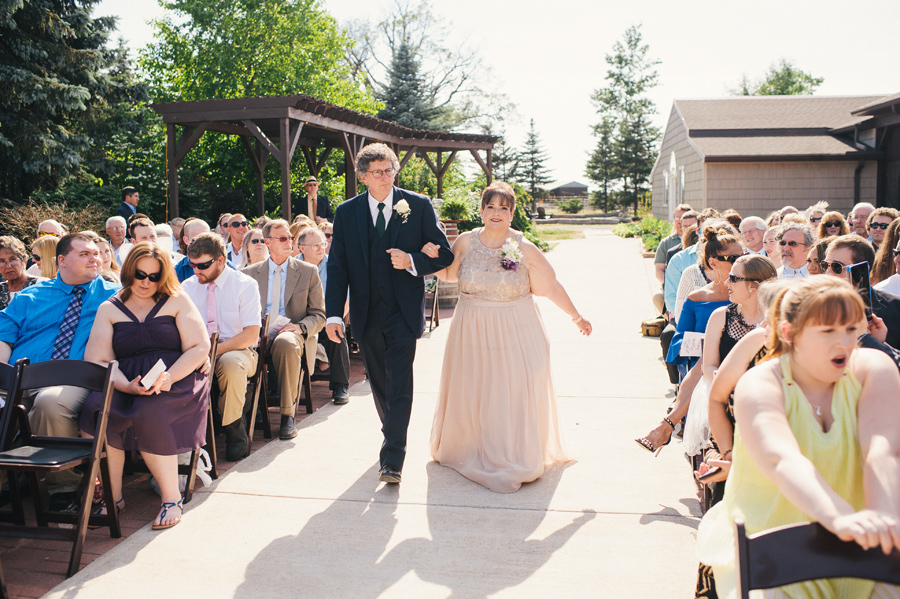 parents of the bride walking down the aisle