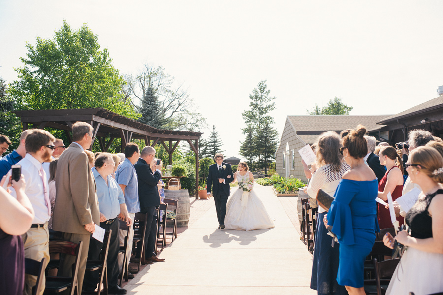 bride's father escorting her down the aisle at becker farms