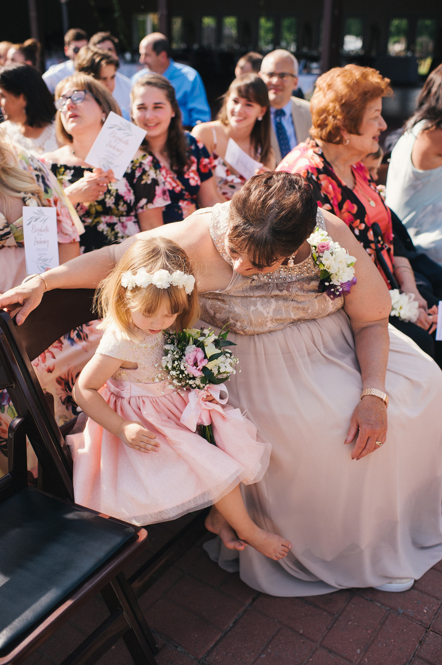 mother of the bride talking with flower girl