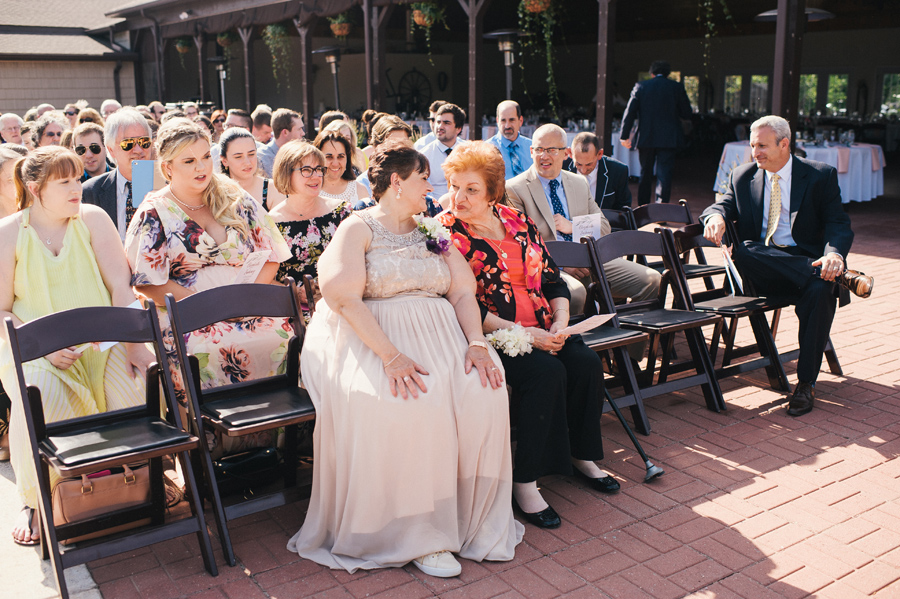 wedding guests smiling during the ceremony at becker farms