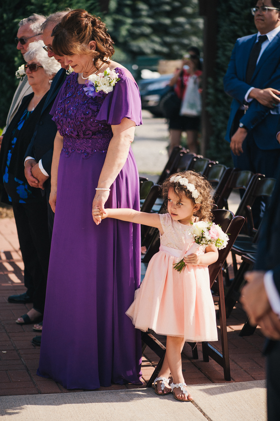 flower standing and holding a wedding guest's hand