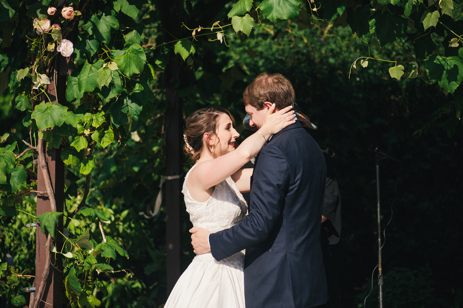 bride and groom hold each other while bride cries