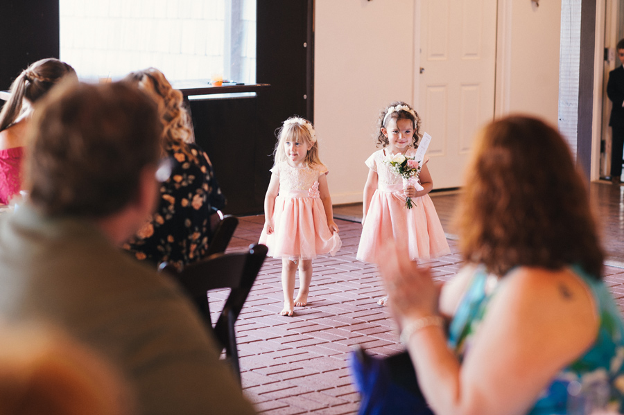 flower girls walking into reception together