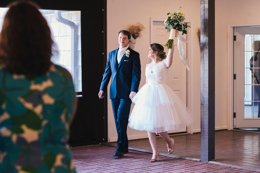 bride wearing short dress with groom for grand reception entrance