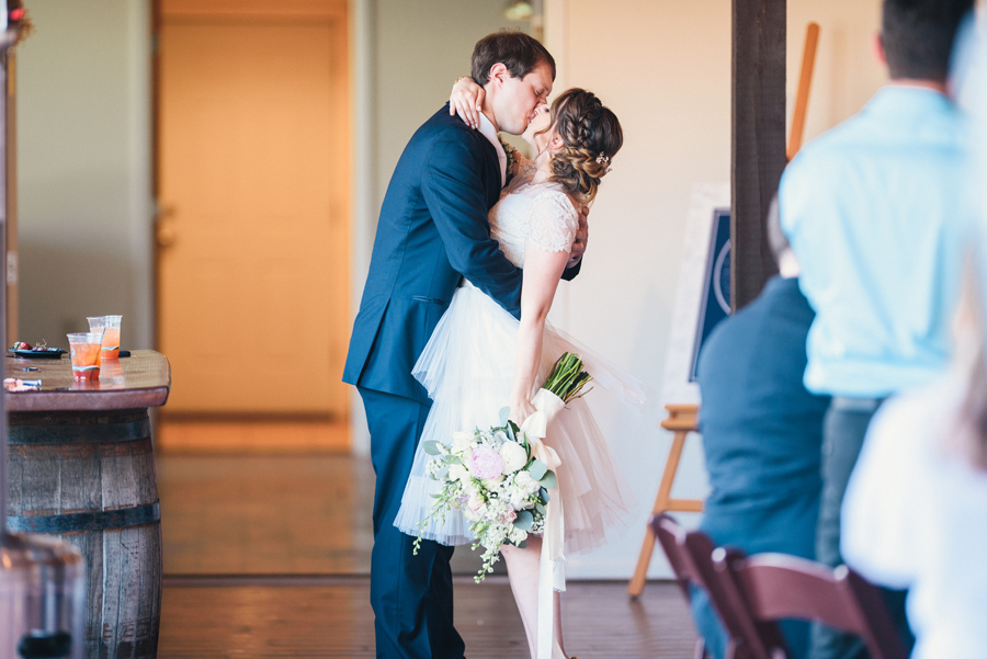 bride and groom kissing in the reception area