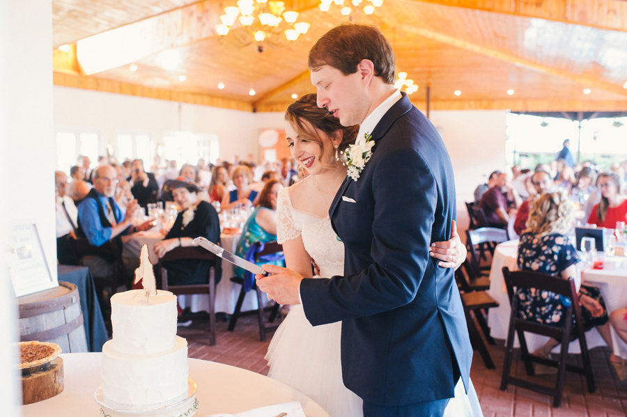 bride and groom cutting cake at becker farms reception party