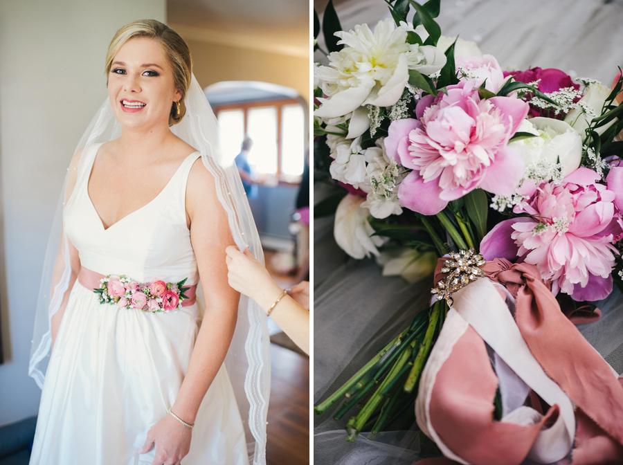 bride in wedding gown with pink flowered belt and bouquet