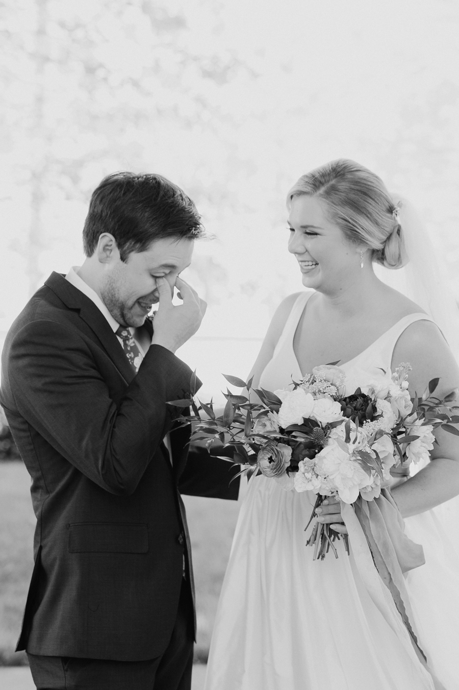 black and white photo of groom crying during first look