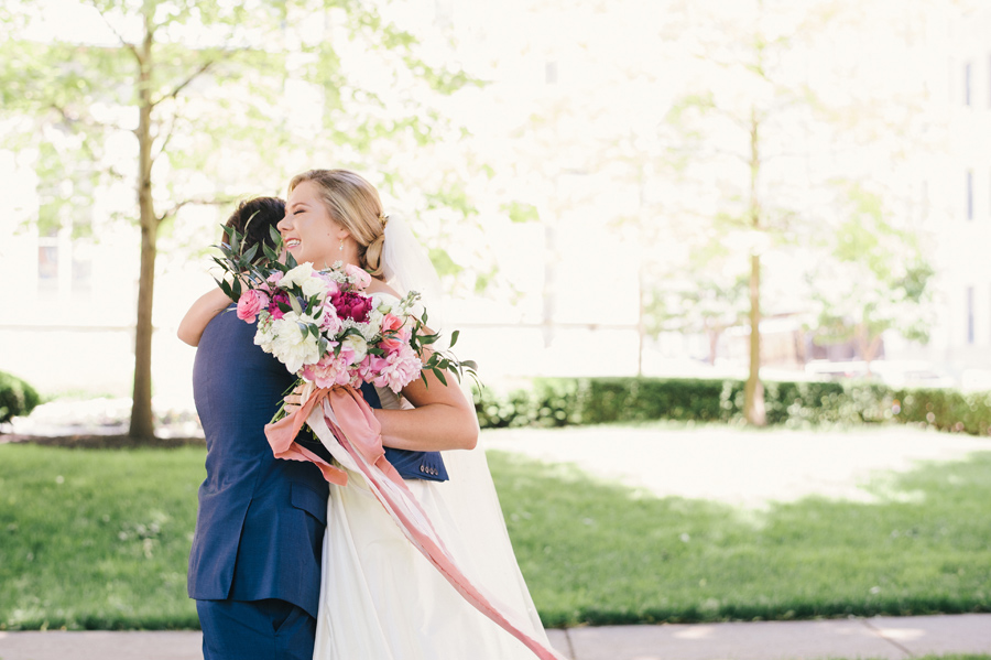 bride and groom hugging in the park