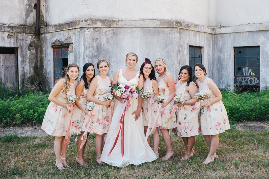 bride with bridal party in short pink floral dresses