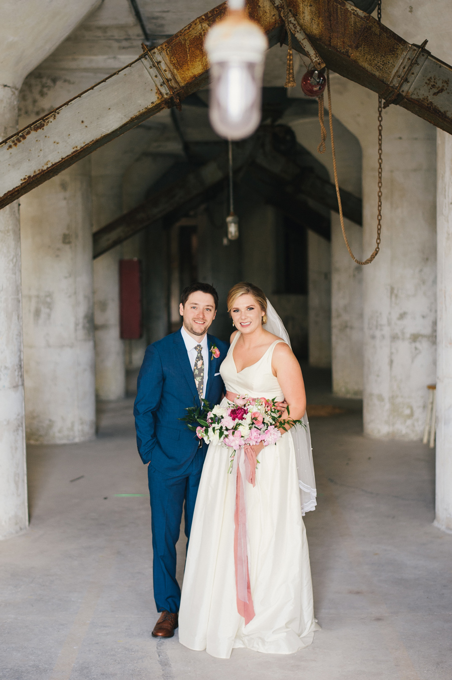 bride and groom posing inside a grain silo