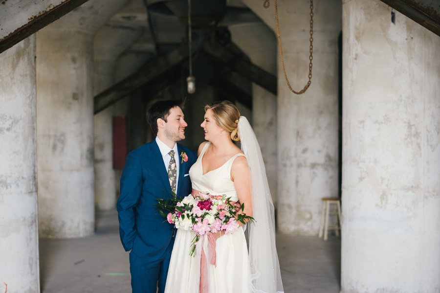 bride and groom smiling at each other inside silo city