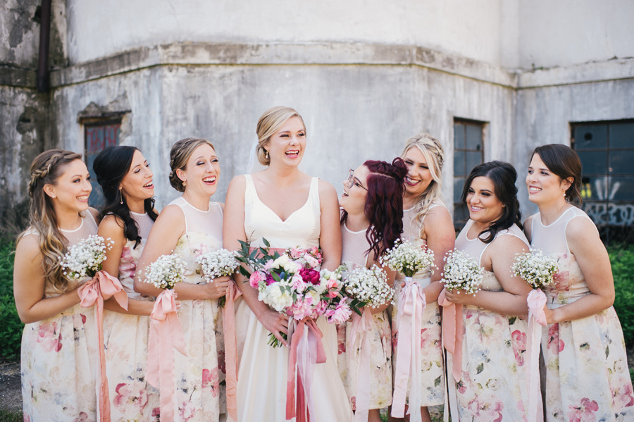 bride and bridesmaids laughing with each other at silo city