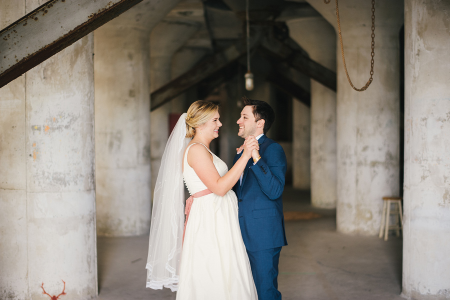 bride and groom dancing inside grain silo