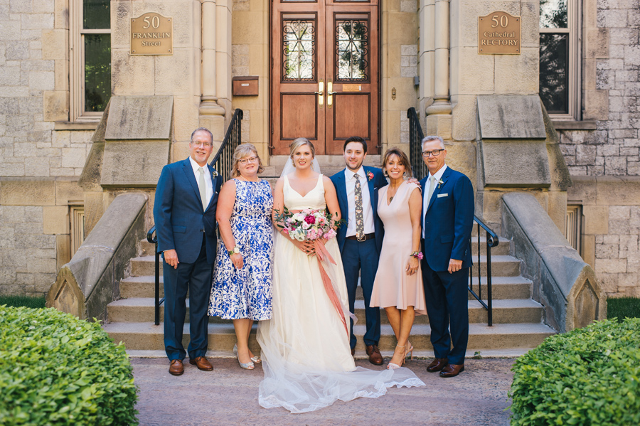 bride and groom with their parents in front of st joseph cathedral