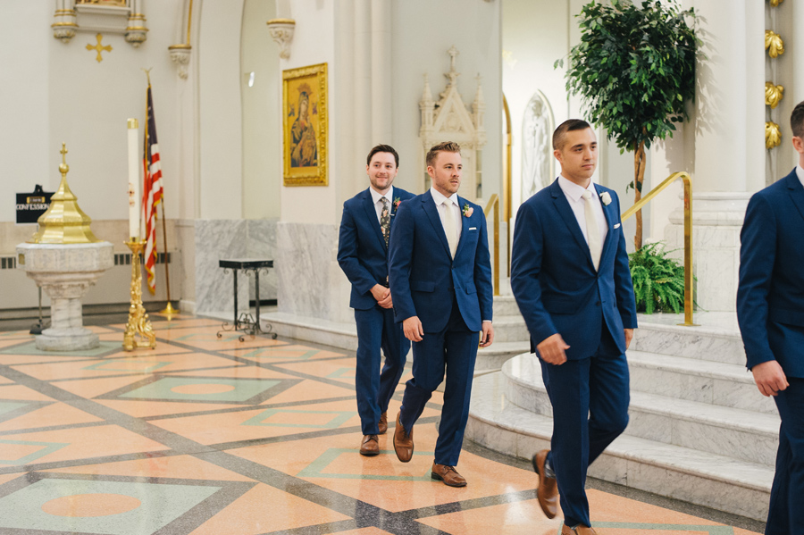 groom and groomsmen walking to the altar at st joseph cathedral