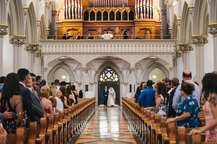 bride and her father entering the aisle at st joseph cathedral