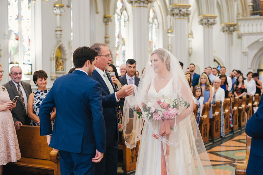 father of the bride lifting her veil