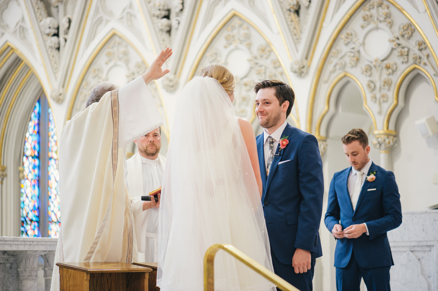 priest praying over the bride and groom