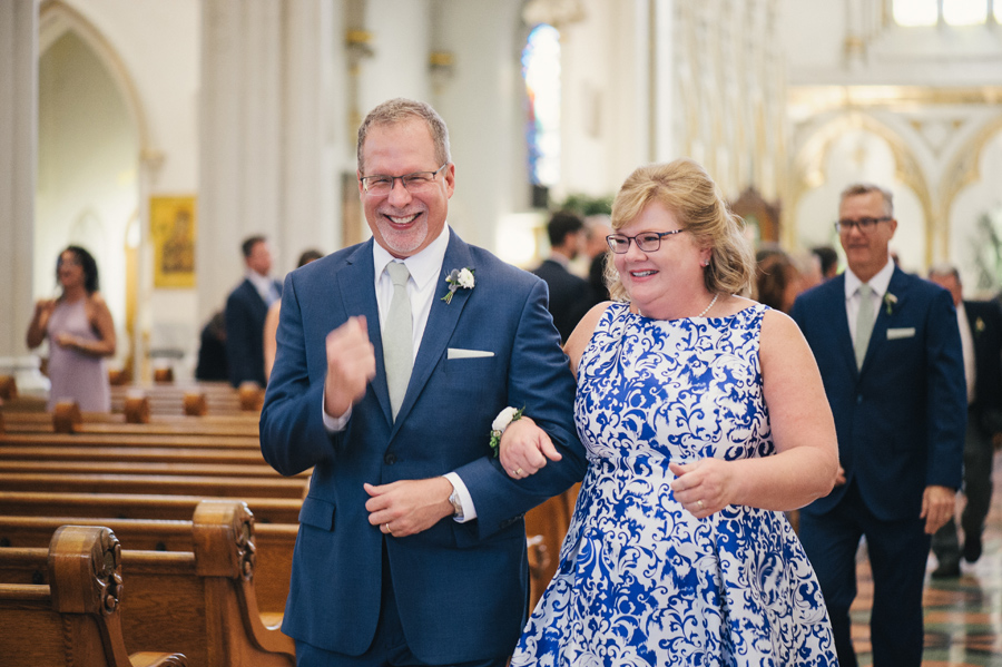 bride's parents walking up the aisle together after the ceremony