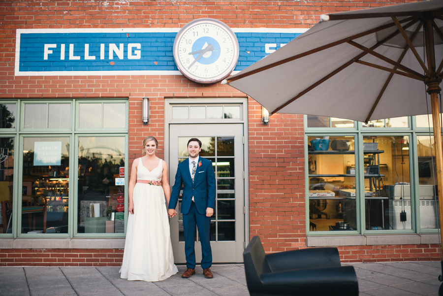 bride and groom holding hands in front of larkinville