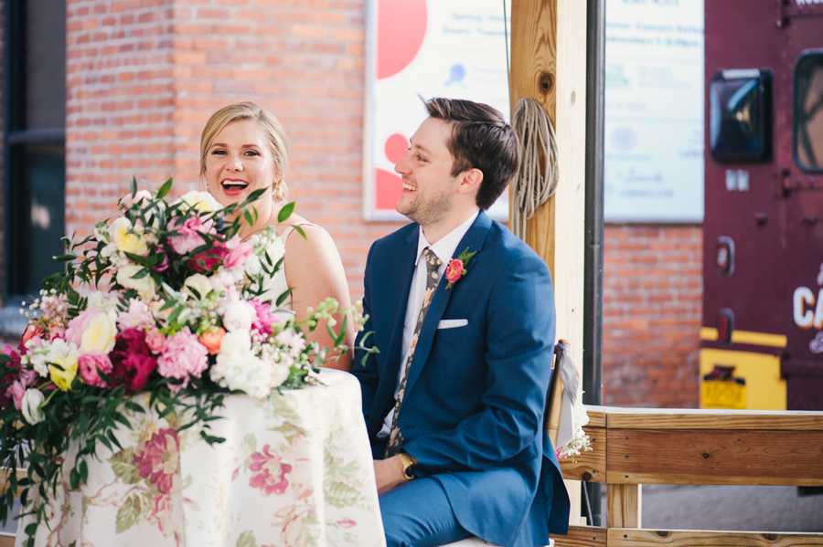 bride and groom laughing during speeches