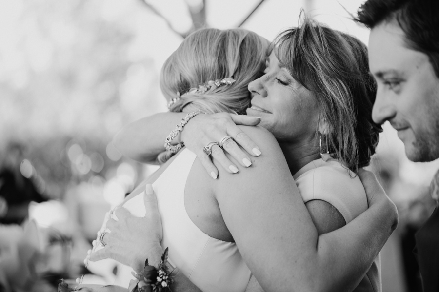 black and white photo of groom's mother hugging the bride