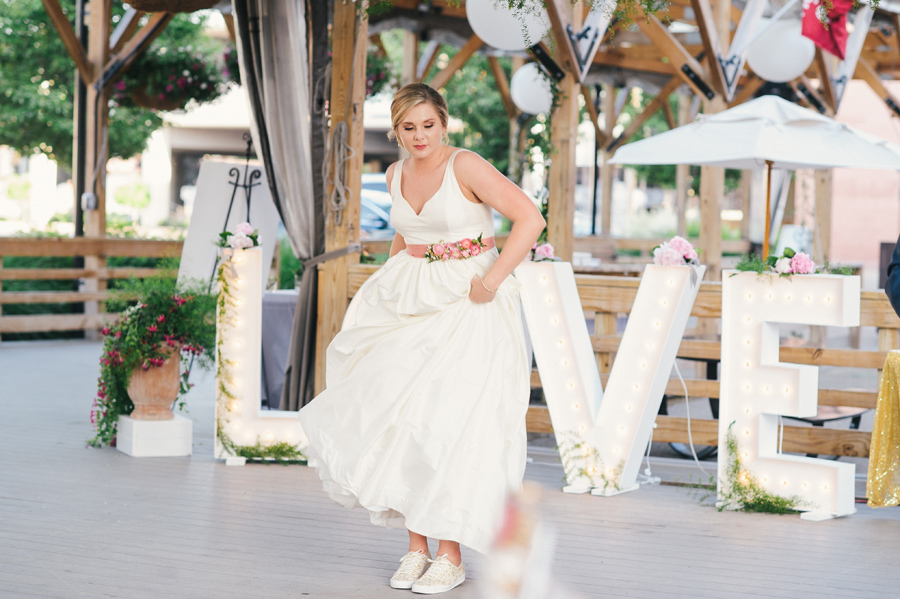 bride showing off her dancing sneakers on the dance floor