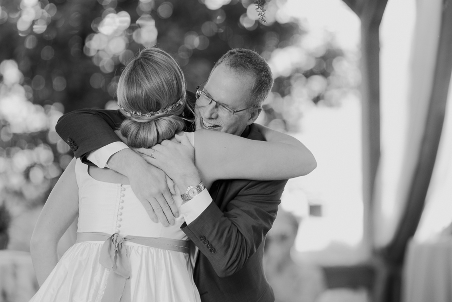 black and white photo of bride hugging her father
