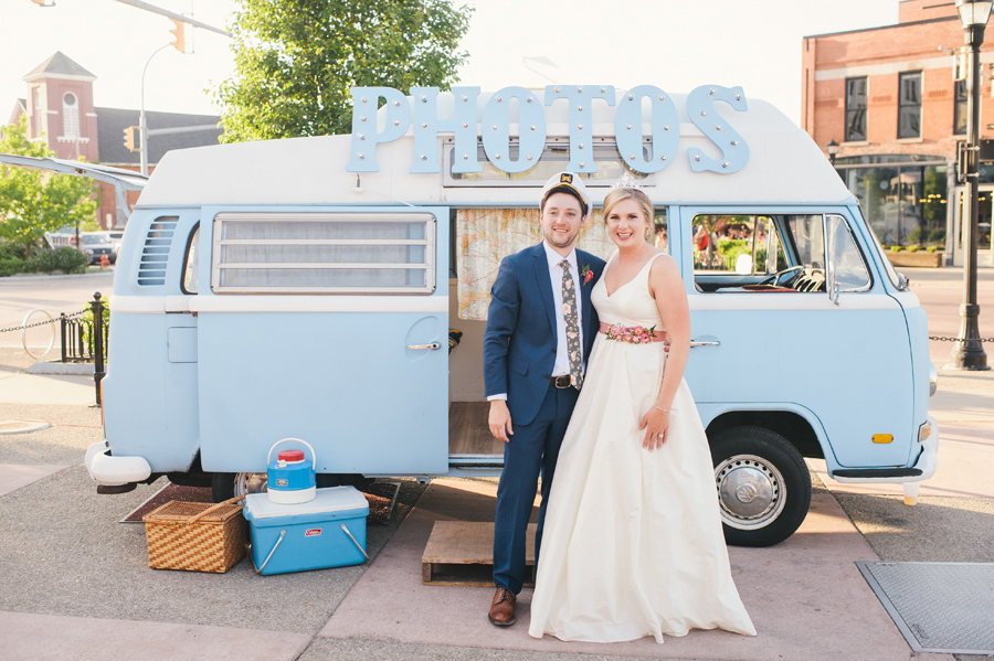 bride and groom standing in front of buffalove bus photo booth