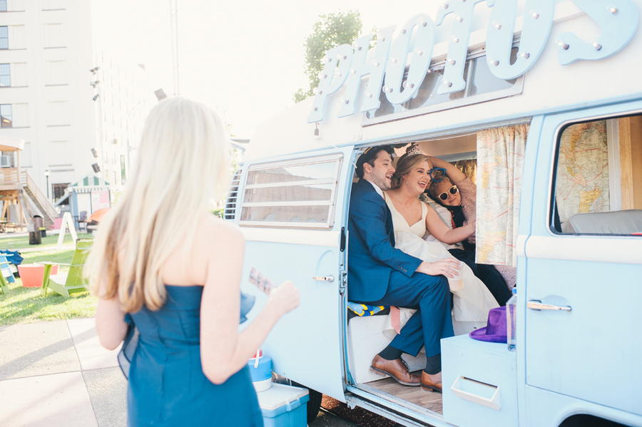 bride and groom taking photos inside photo booth