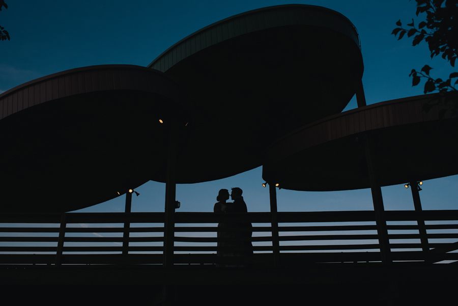 nighttime photo of bride and groom silhouette 