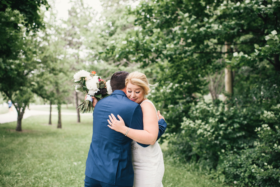 bride and groom hugging after the first look