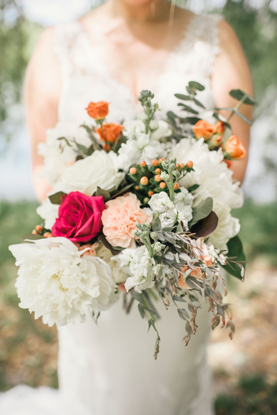 close up of bride's white hot pink and orange bouquet from williams florist