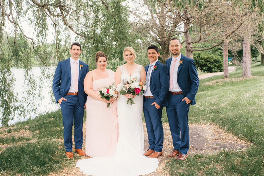 wedding party posing under a willow tree in delaware park