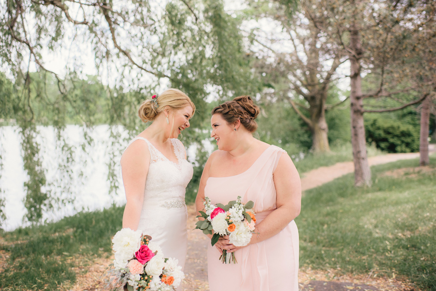 bride laughing with maid of honor in delaware park