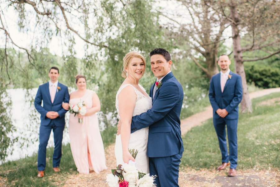 wedding party posing on a path in the park