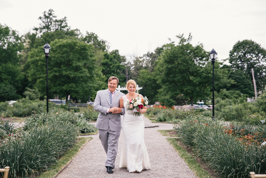 bride and her father smiling as the come down the aisle