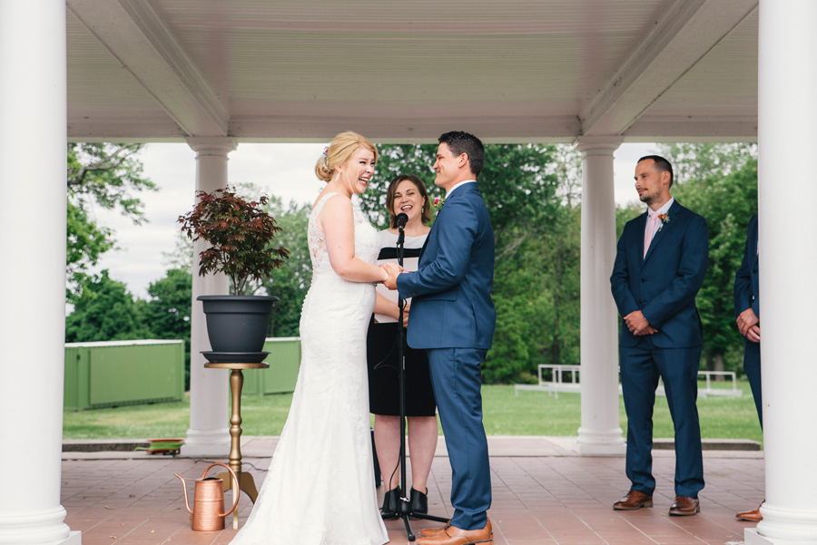 bride and groom laughing during wedding ceremony