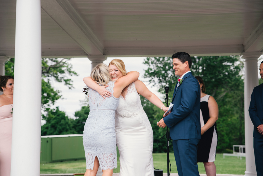 bride hugging a speech giver during the ceremony