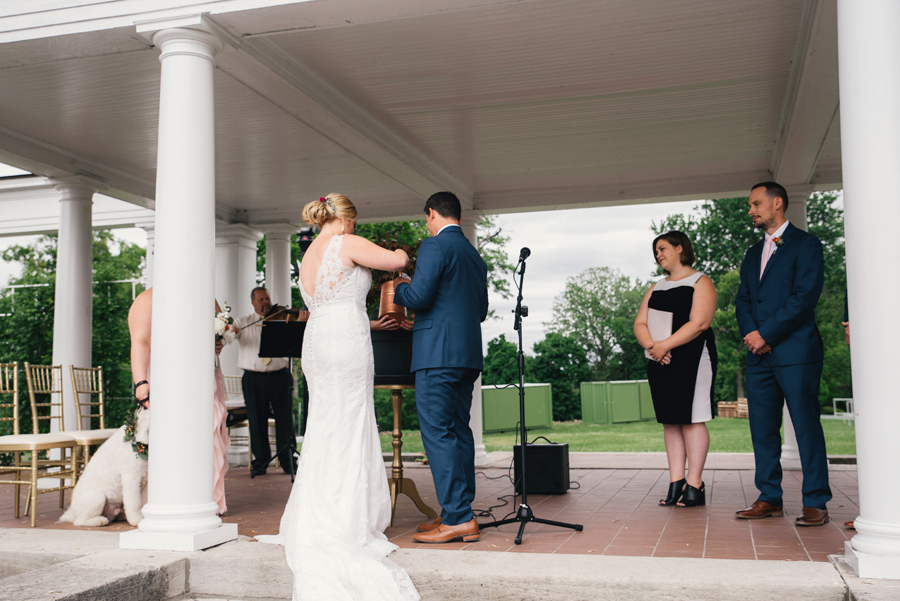 bride and groom watering a tree during plant ceremony at wedding