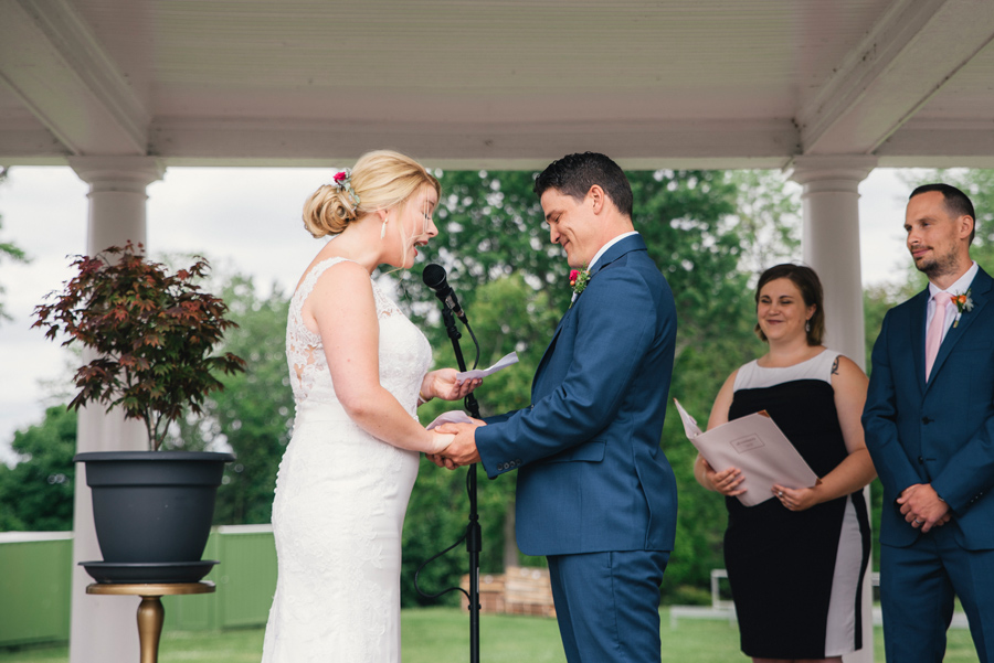 bride and groom reading vows to each other