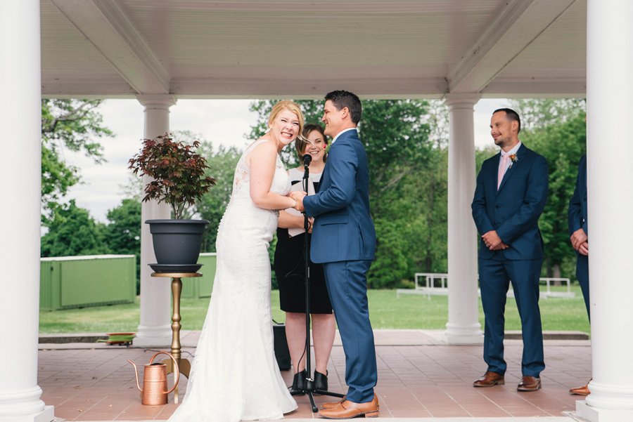 bride and groom laughing during vow exchange