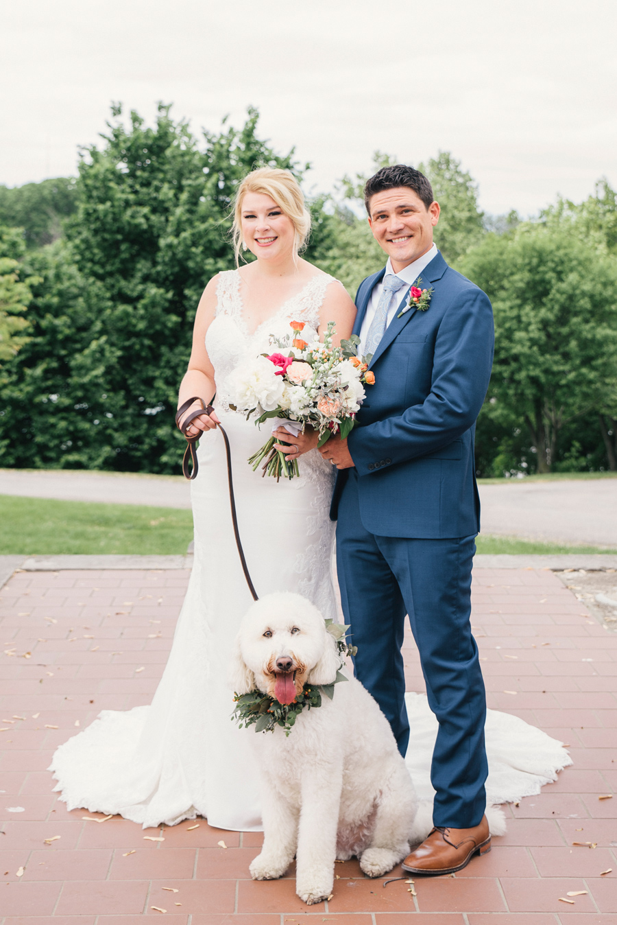 bride and groom posing with their dog at delaware park