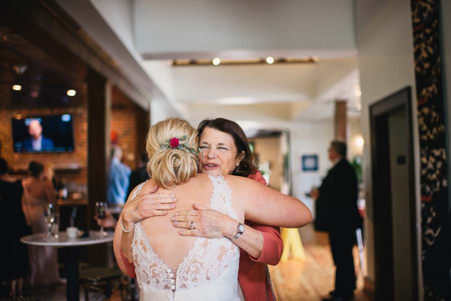 bride hugging a wedding guest at the reception