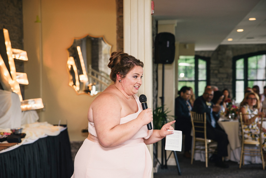 maid of honor delivering a speech to bride and groom