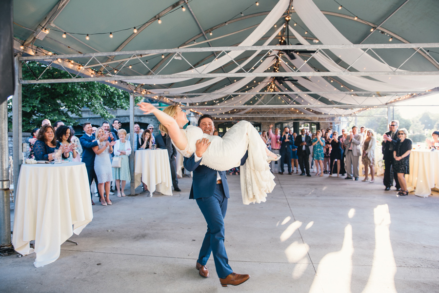 groom lifting bride on the dance floor